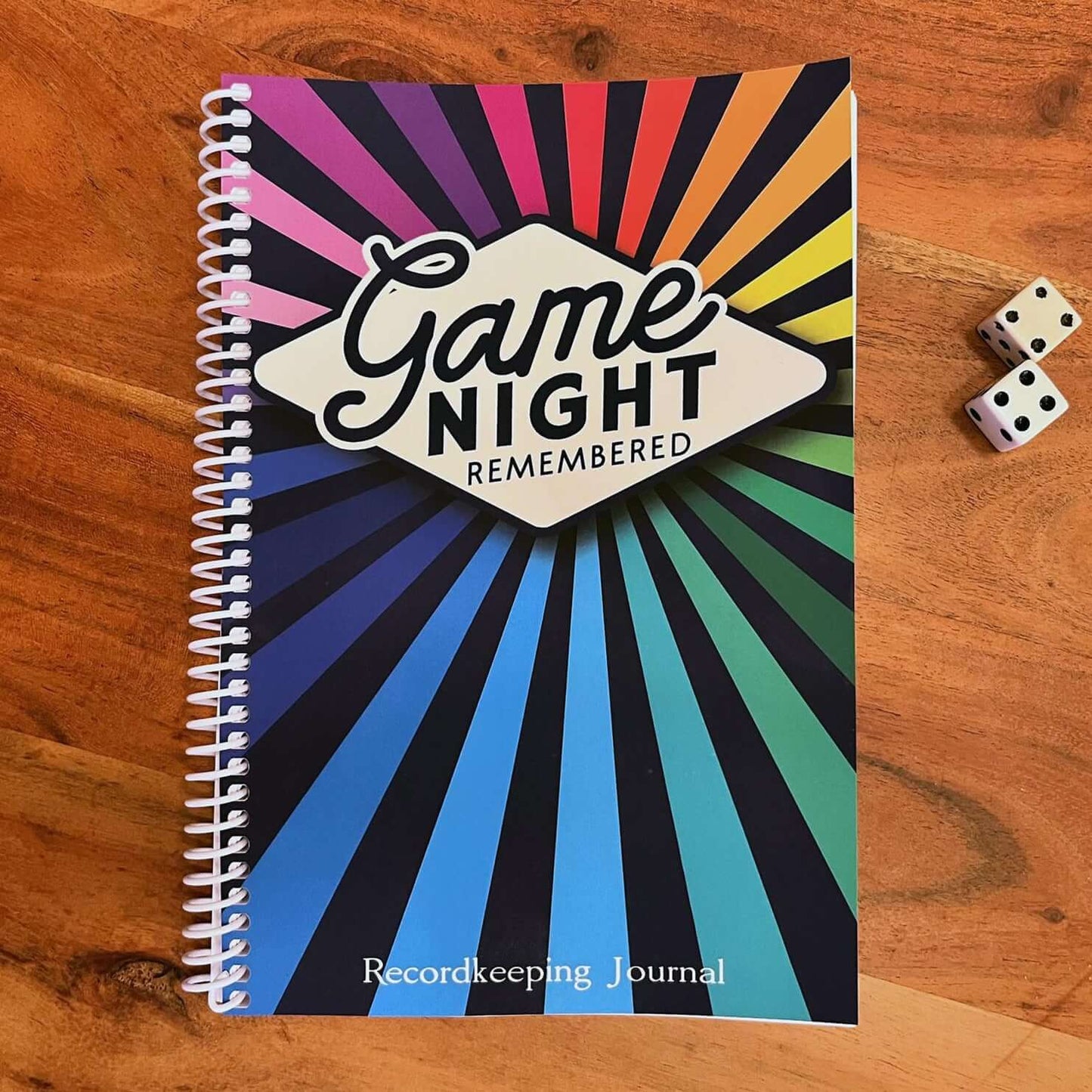 Colorful Game Night Remembered journal for board game tracking, measuring 6x9 inches with a coil-bound design.