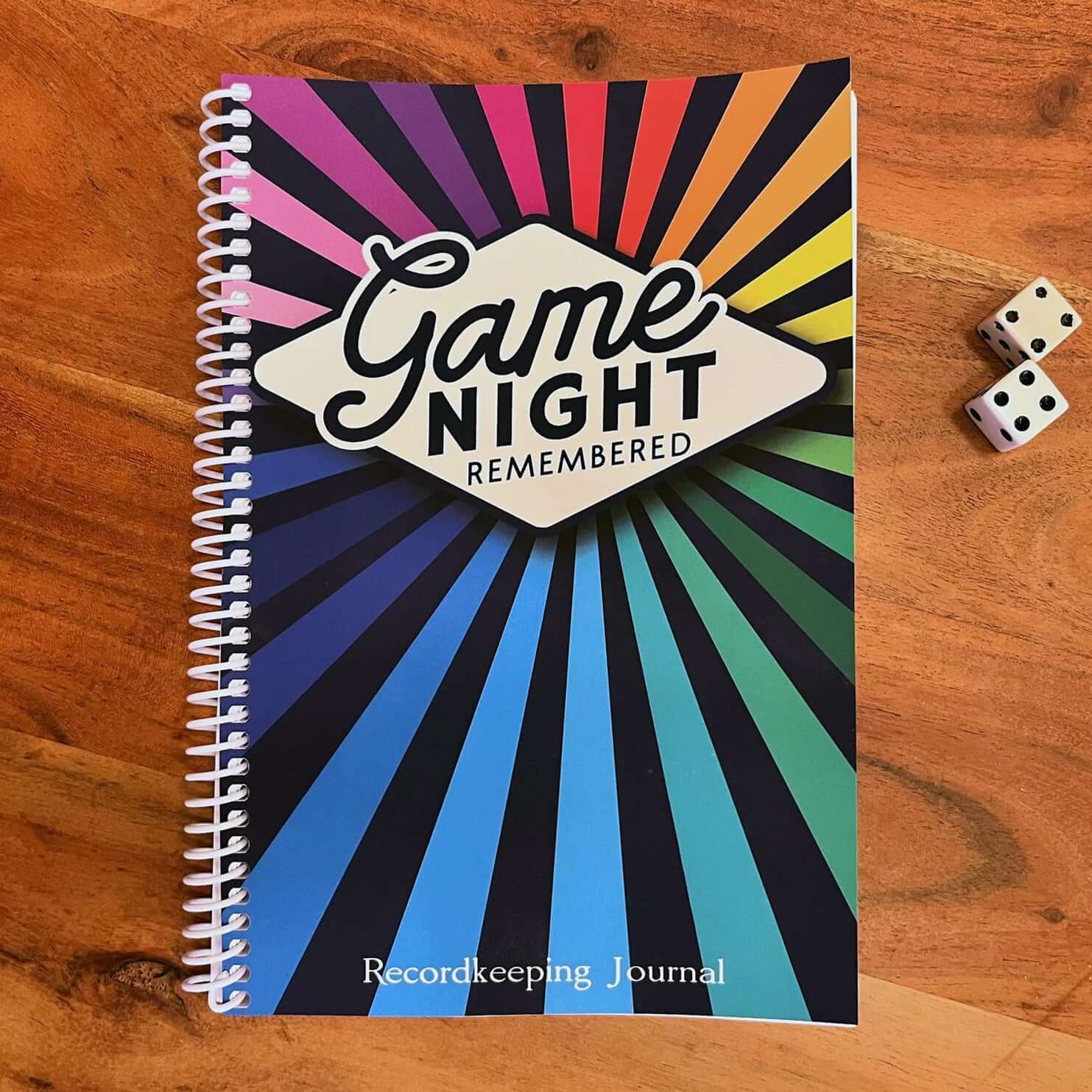 Colorful Game Night Remembered journal for board game tracking, measuring 6x9 inches with a coil-bound design.