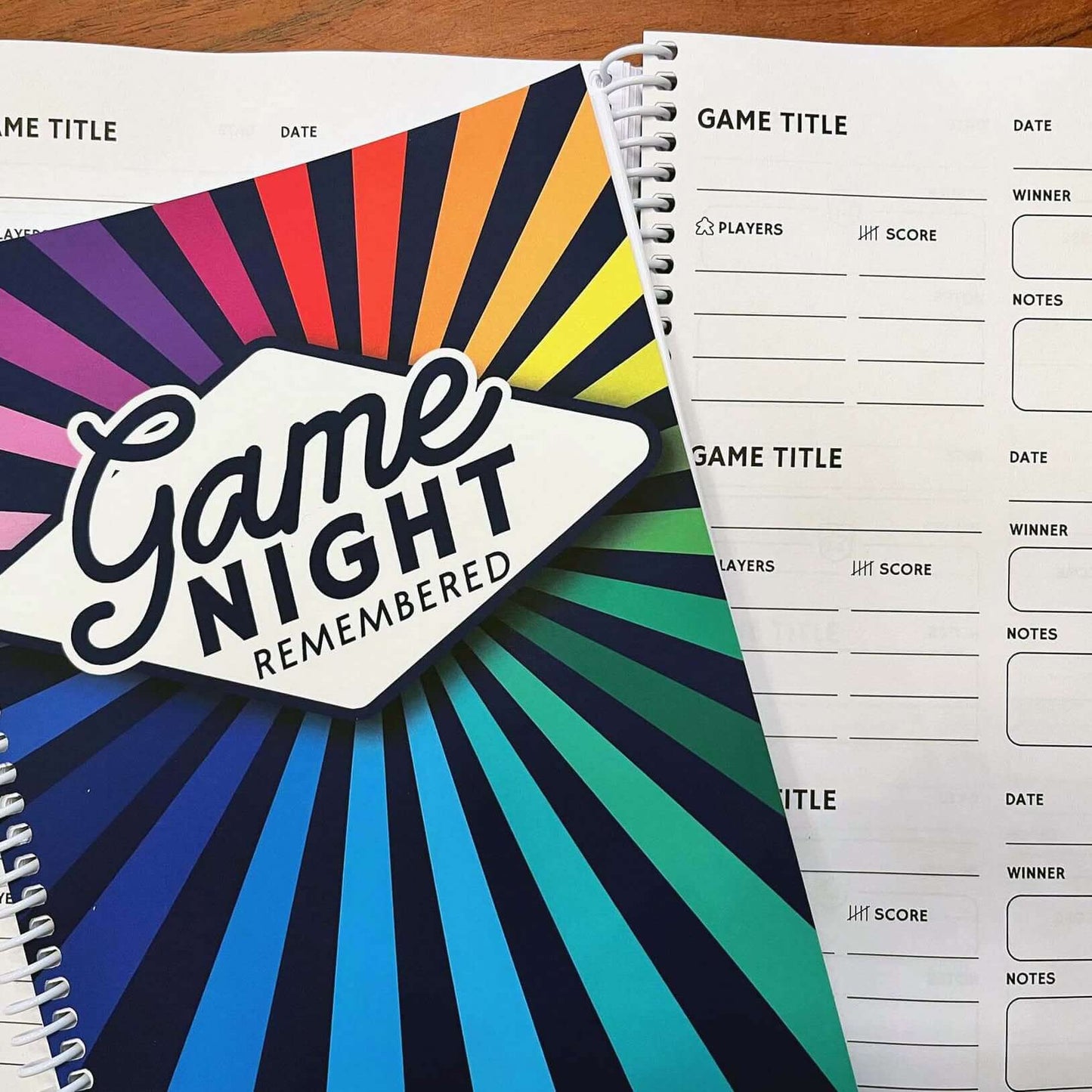 Colorful Game Night Remembered journal with game tracking pages for board game enthusiasts.