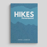 Hikes Remembered hiking logbook journal with a blue cover featuring topographic design and bold title.